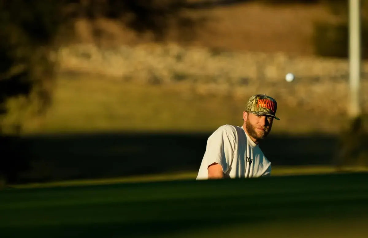 Grass League player reads the green in afternoon light