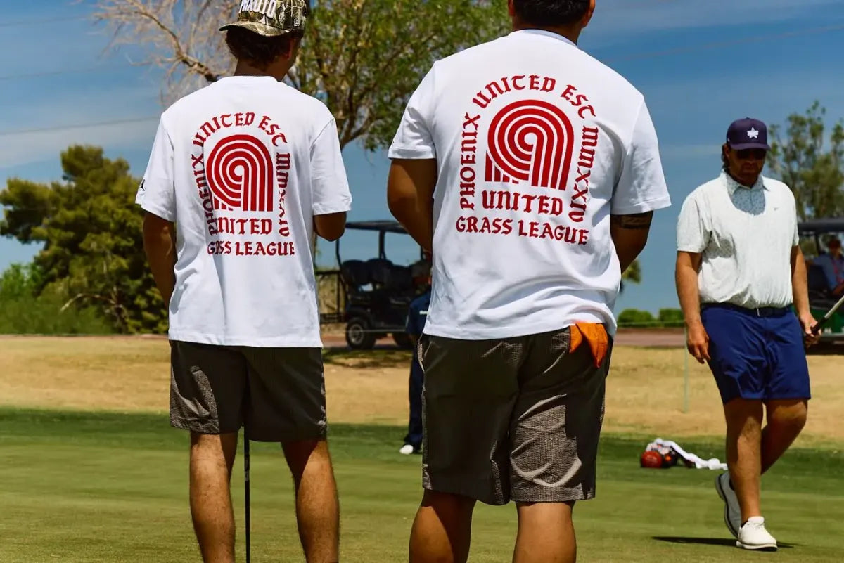 Phoenix United players in branded tees walking the par-3 course